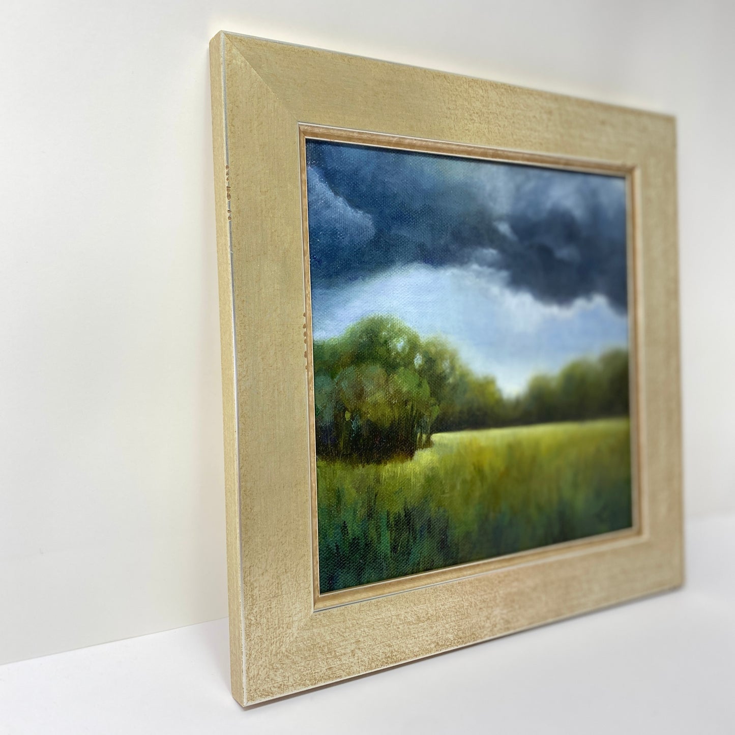 Framed original oil painting of a landscape with trees and sky.