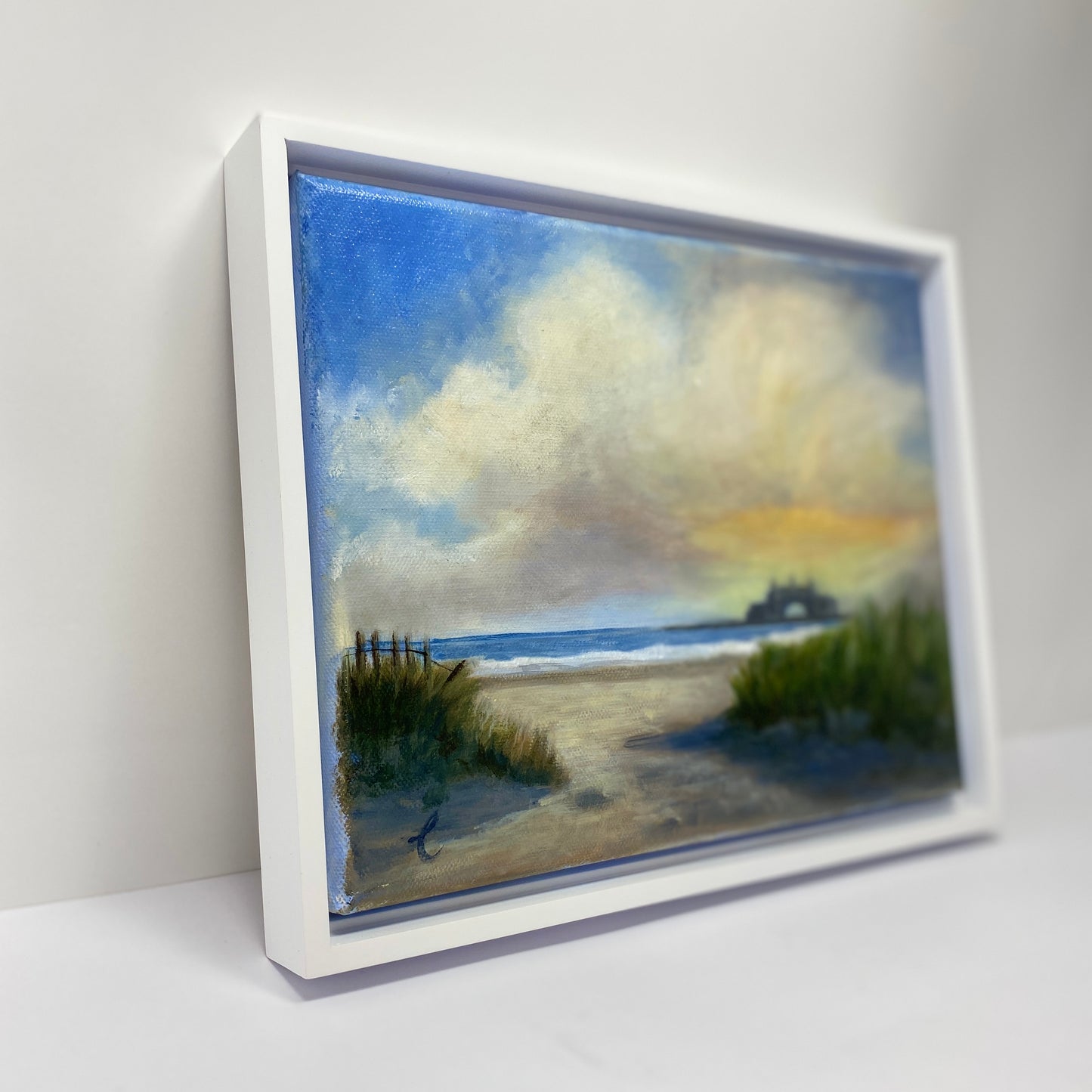 Framed Narragansett beach scene painting with a white frame on a light gray background