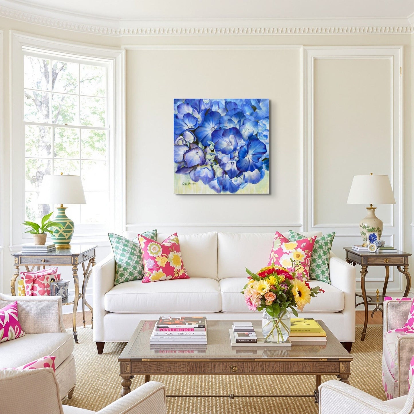 Living room with Echoes of Blue original oil painting on wall over a white sofa, colorful pillows, and accessories with a lived-in decor.
