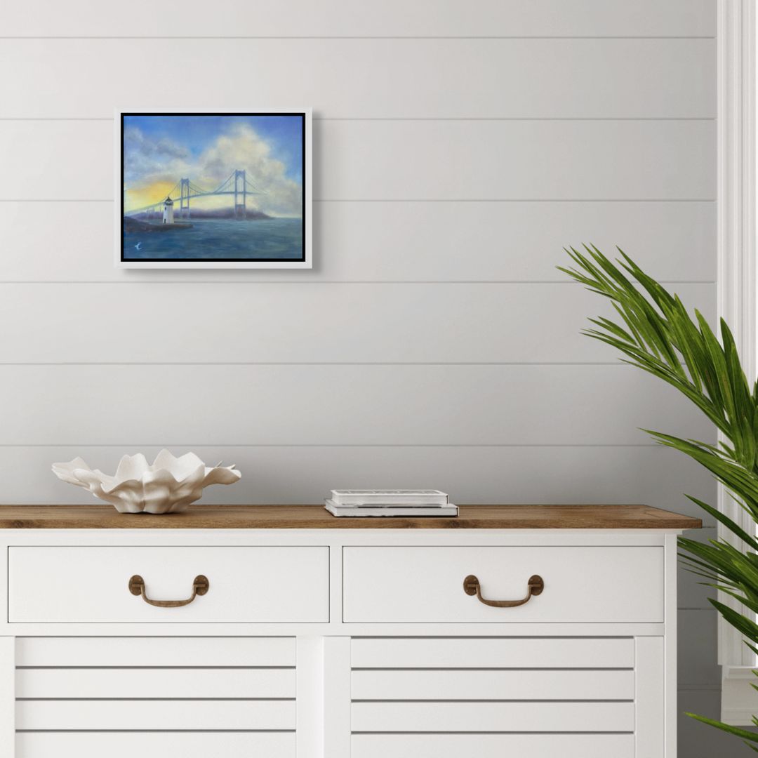 White dresser with wooden top, framed oil painting of Goat Island ighthouse, Newport RI above, and plant on a light gray wall.