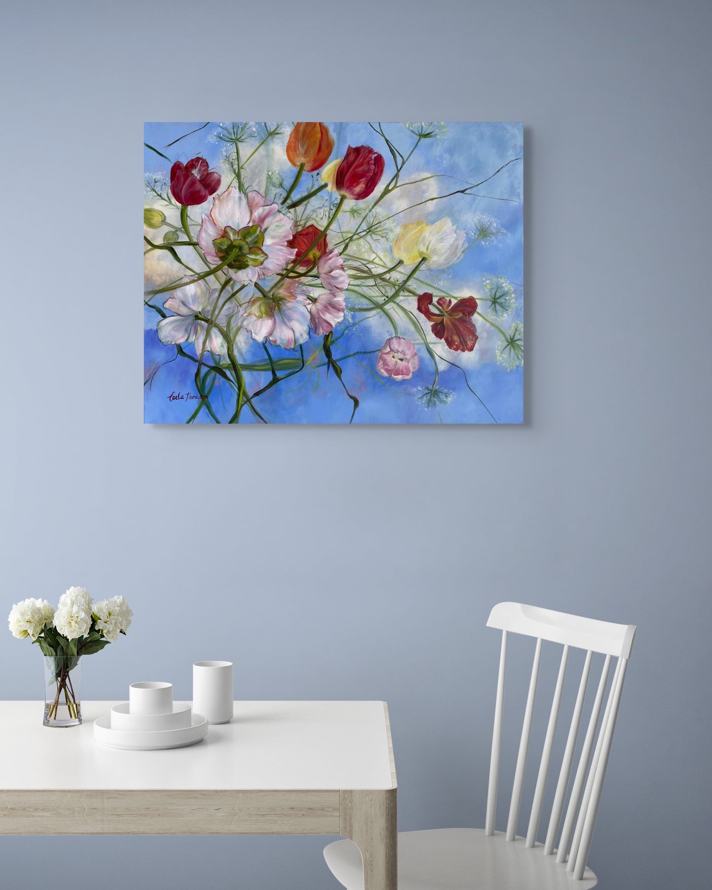 Wishful Thinking a colorful original floral oil painting on a wall above a dining table with a vase of flowers.