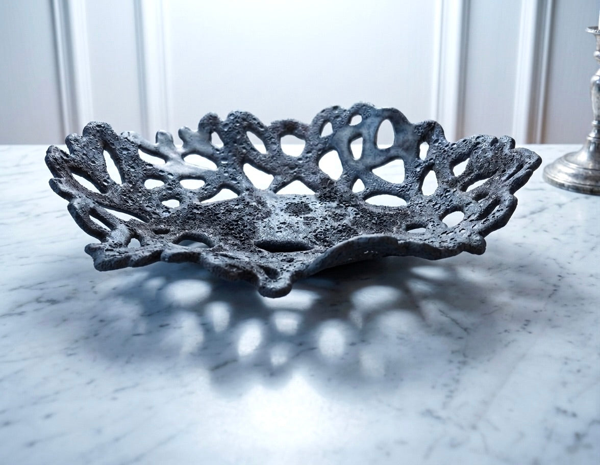Openwork: Coastal — Nighttide ceramic bowl on marble surface, showing openwork rim and dark coastal glaze