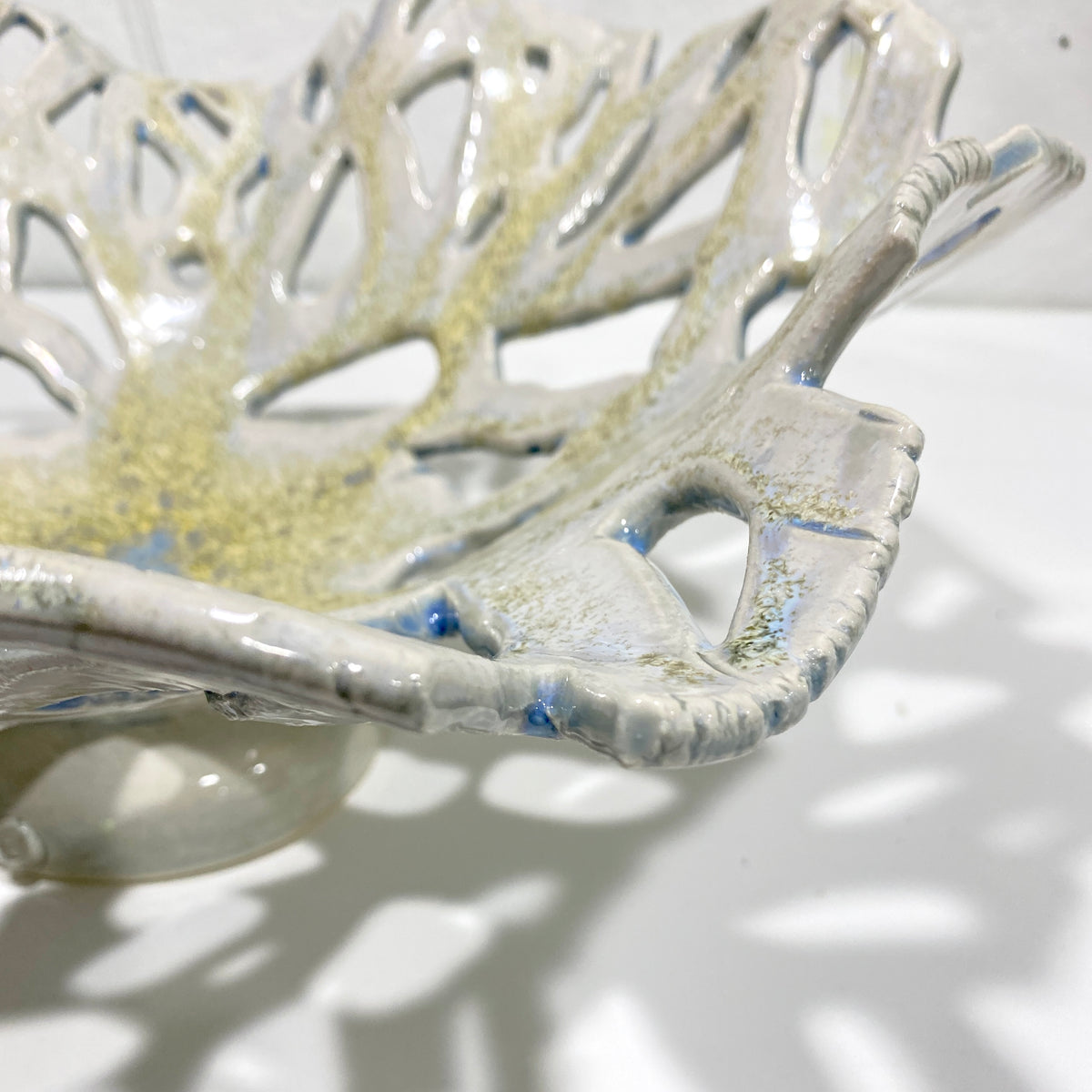 Openwork: Coastal — Reef, close-up detail of openwork rim showing blue inclusions surfacing through white glaze and crystalline texture