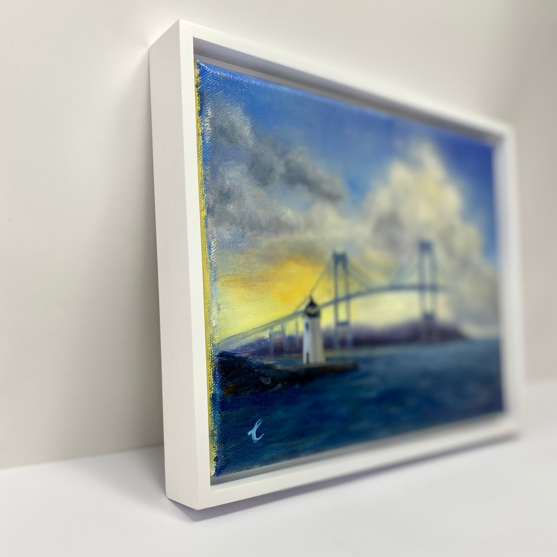 Framed artwork of a Goat Island ighthouse, Newport RI  and bridge with a white border.
