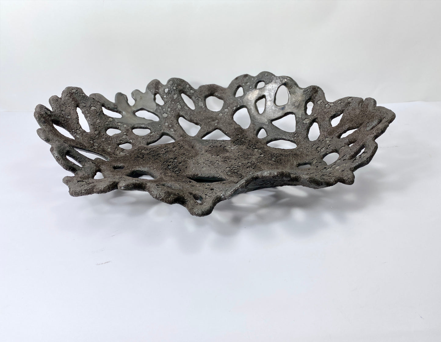 Openwork: Coastal — Nighttide, three-quarter view showing depth of bowl and volcanic surface texture