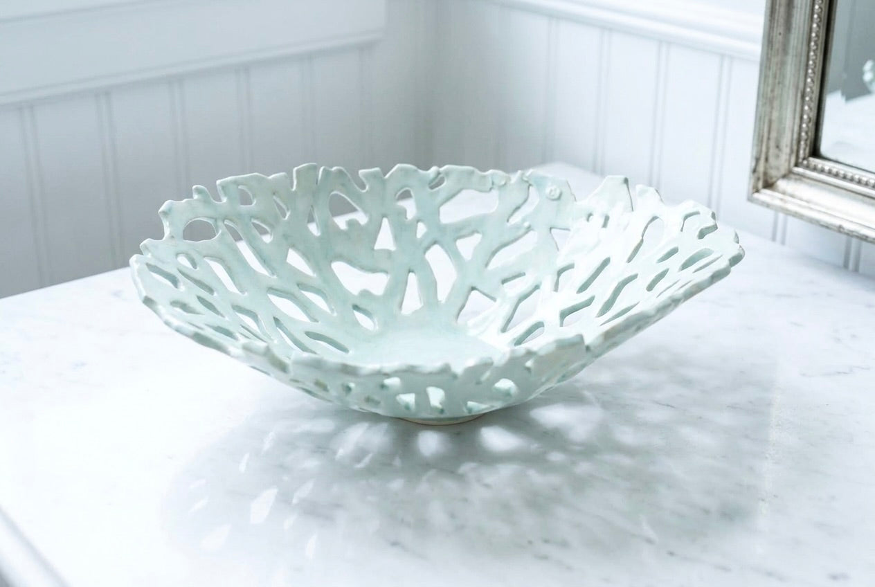 Openwork: Coastal — Seaglass ceramic bowl on marble surface, showing uniform celadon glaze and organic openwork pattern