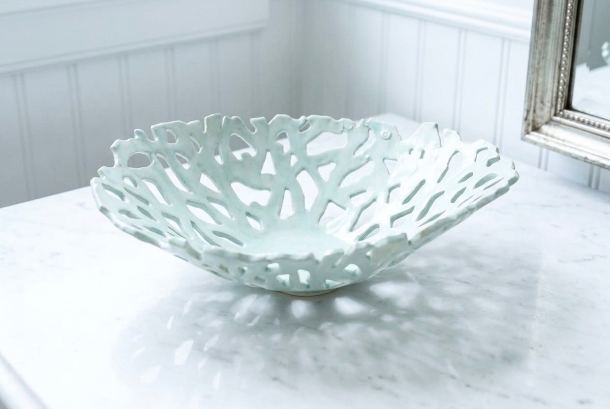 Openwork: Coastal — Seaglass ceramic bowl on marble surface, showing uniform celadon glaze and organic openwork pattern