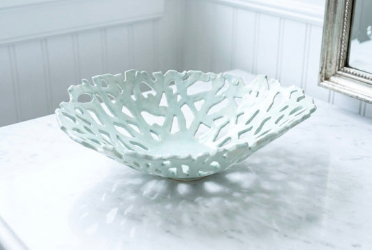 Openwork: Coastal — Seaglass ceramic bowl on marble surface, showing uniform celadon glaze and organic openwork pattern