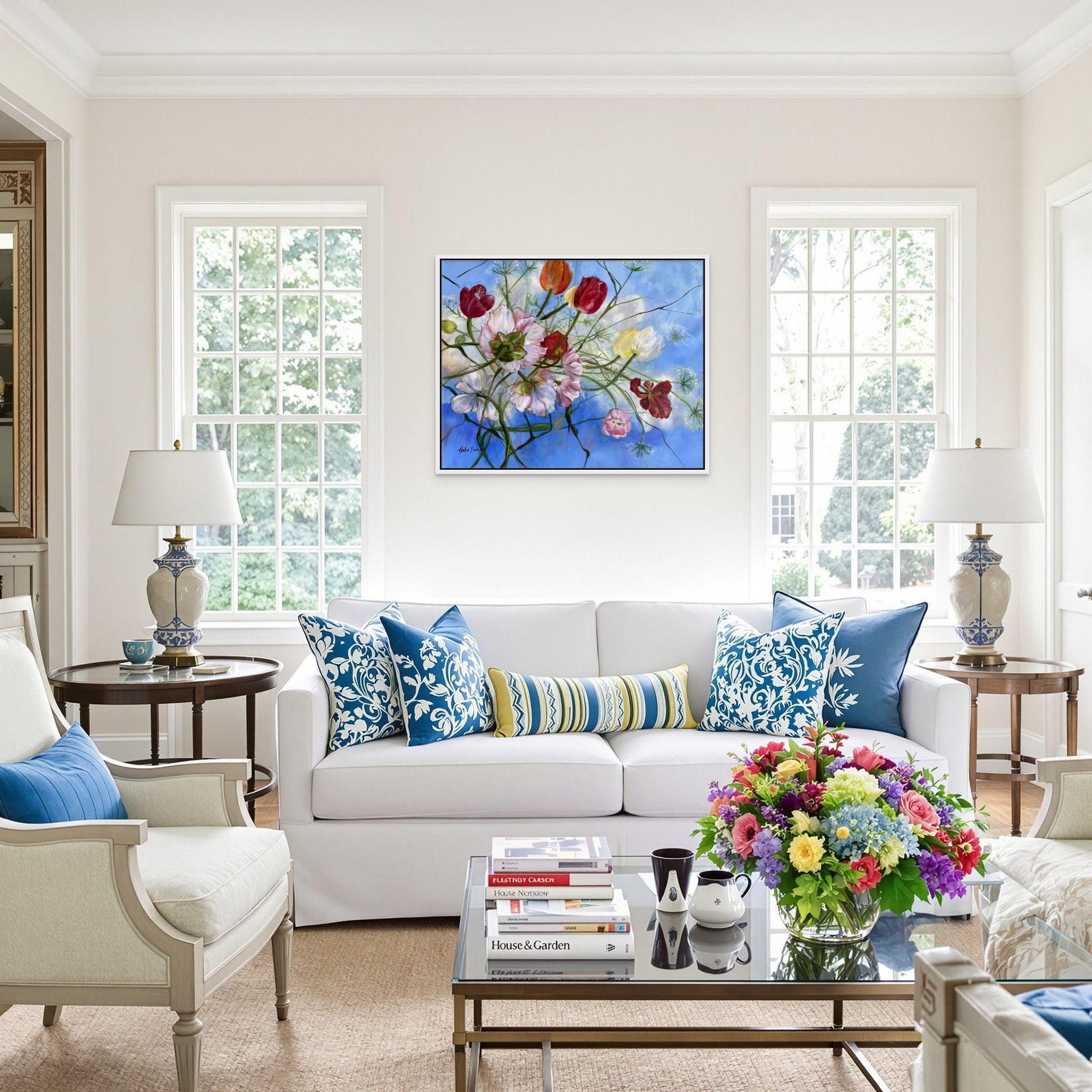 Wishful Thinking a colorful original floral oil painting in a Living room with a white sofa, colorful pillows, and flowers.