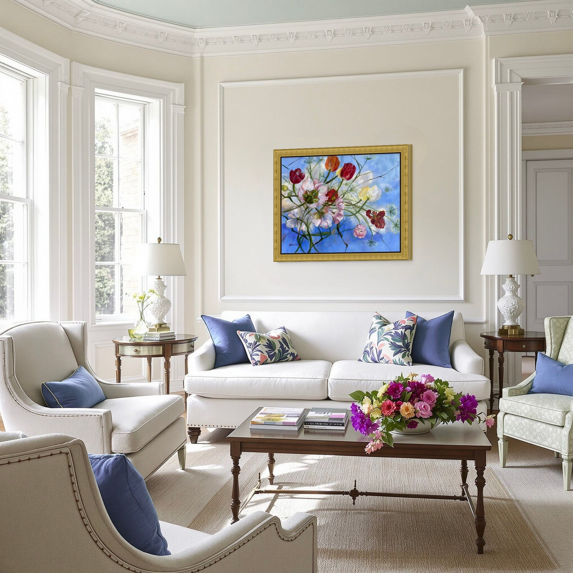 'Wishful Thinking' a colorful original floral oil painting on Living room wall over a white sofa, armchairs, and a coffee table with decorative items.